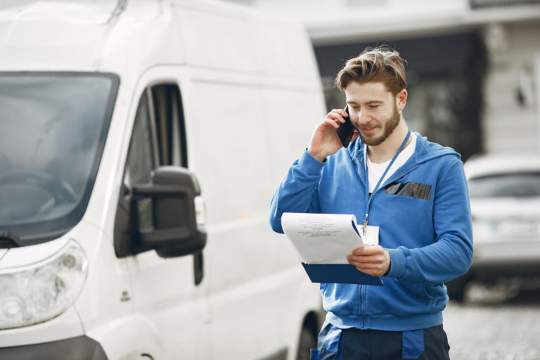 Delivery man with package outdoors